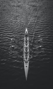 people riding boat on body of water